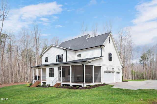 1124 Westridge Rd, Rougemont, NC 27572 - rear view of house featuring a lawn, a shingled roof, concrete driveway, an attached garage, and a sunroom
