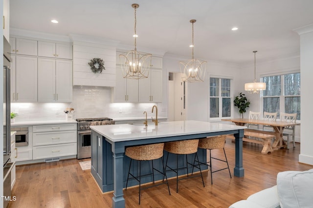1124 Westridge Rd, Rougemont, NC 27572 - kitchen with high end stove, light countertops, white cabinetry, crown molding, and a chandelier