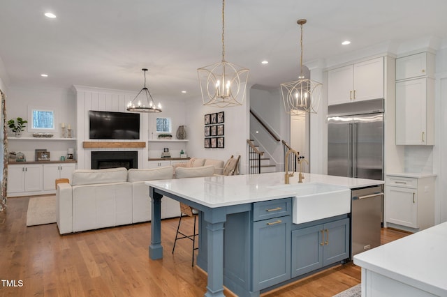 1124 Westridge Rd, Rougemont, NC 27572 - kitchen with white cabinets, stainless steel appliances, light countertops, and a sink