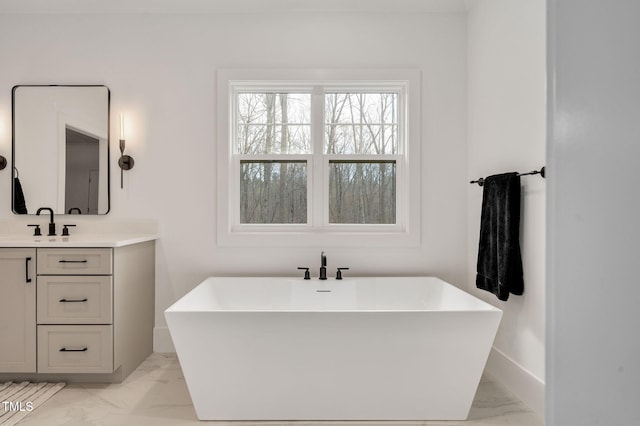 1124 Westridge Rd, Rougemont, NC 27572 - bathroom with vanity, baseboards, marble finish floor, and a freestanding bath