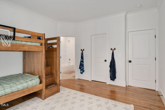 1124 Westridge Rd, Rougemont, NC 27572 - bedroom with baseboards, wood finished floors, ensuite bath, and ornamental molding