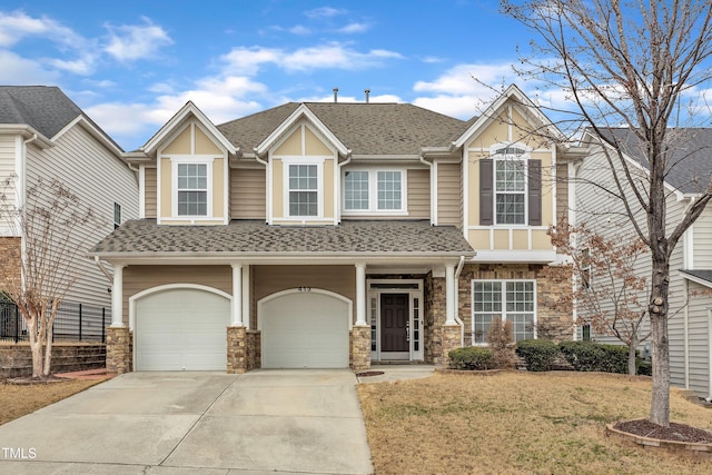 view of front of home featuring driveway, a garage, a shingled roof, stone siding, and a front yard