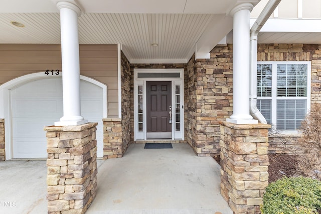 property entrance featuring stone siding and a porch