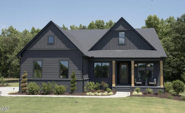 view of front of home featuring a porch, board and batten siding, a front yard, and a shingled roof