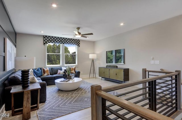 living area with ceiling fan, baseboards, wood finished floors, and recessed lighting