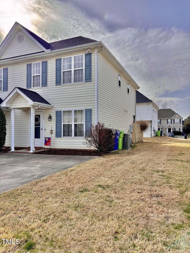 view of front of house featuring central AC and a front lawn