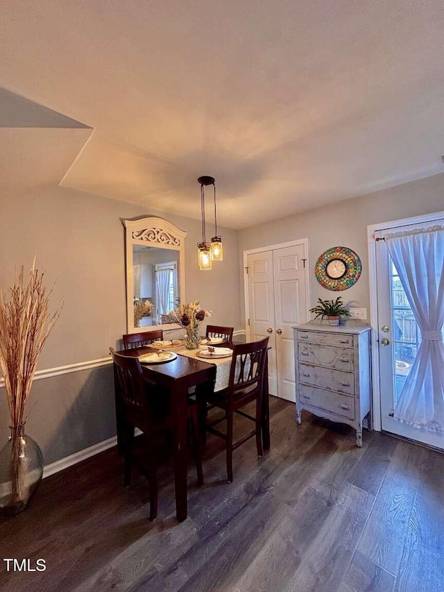 dining area featuring dark wood finished floors and baseboards