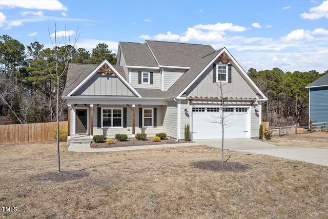 craftsman-style house with driveway, board and batten siding, and fence