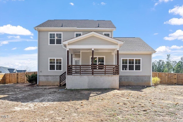 view of front of property with covered porch, fence, and a gate