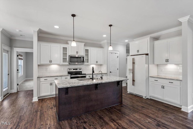 kitchen featuring dark wood finished floors, appliances with stainless steel finishes, white cabinets, and a sink