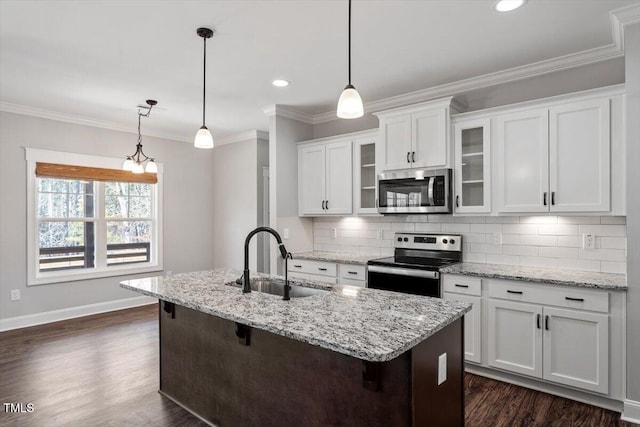 kitchen with decorative backsplash, appliances with stainless steel finishes, dark wood-type flooring, ornamental molding, and a sink