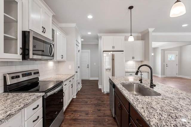 kitchen featuring appliances with stainless steel finishes, white cabinets, glass insert cabinets, and a sink