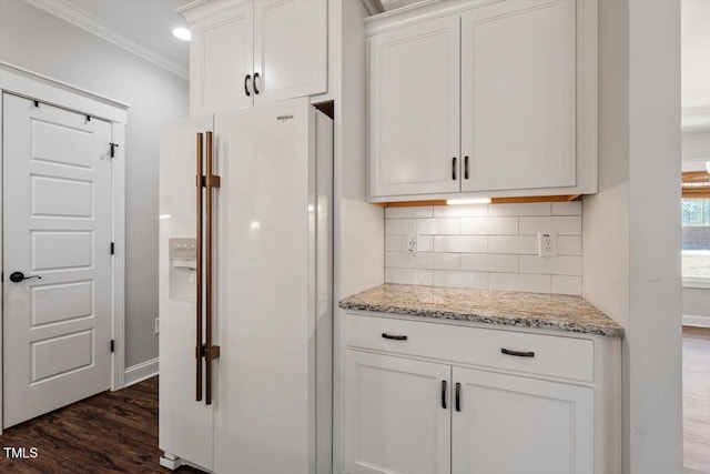 kitchen with white refrigerator with ice dispenser, dark wood-type flooring, white cabinets, and decorative backsplash