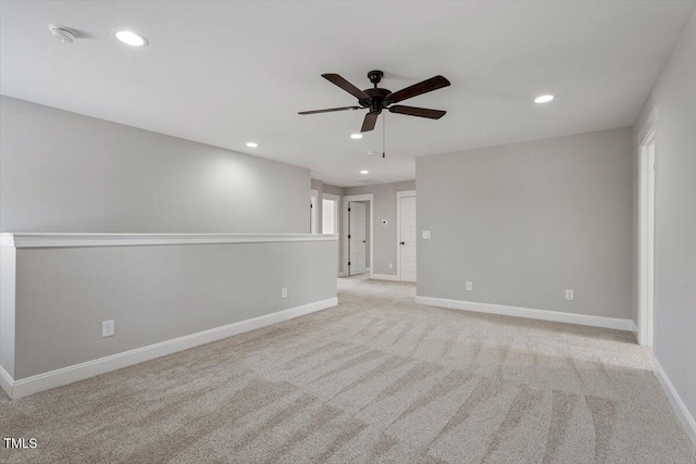 empty room featuring ceiling fan, baseboards, light colored carpet, and recessed lighting