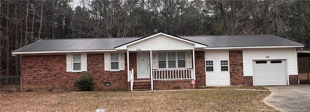 ranch-style house with a garage, covered porch, driveway, and brick siding