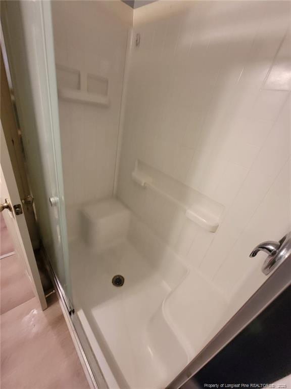 bathroom with a shower stall