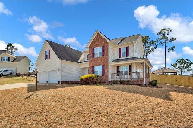 view of front facade with a porch, an attached garage, fence, driveway, and crawl space