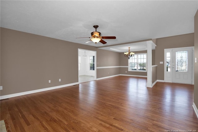 unfurnished living room featuring baseboards, wood finished floors, and ceiling fan with notable chandelier