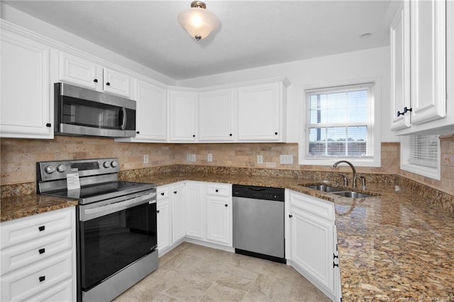 kitchen featuring white cabinets, stainless steel appliances, and a sink