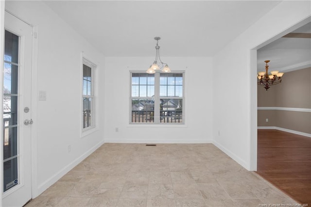 unfurnished dining area featuring a chandelier, visible vents, and baseboards