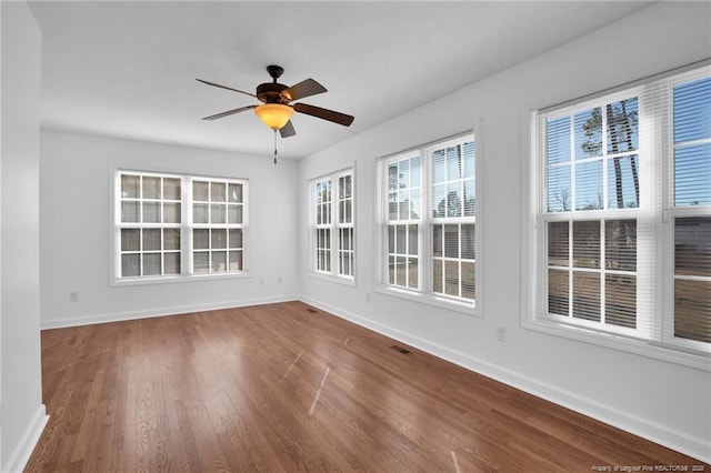 unfurnished sunroom featuring visible vents and a ceiling fan