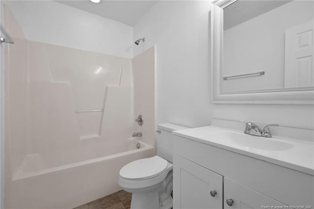 bathroom featuring tub / shower combination, vanity, and toilet