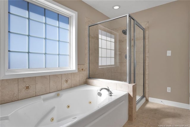 bathroom with a whirlpool tub, baseboards, a shower stall, and tile patterned floors