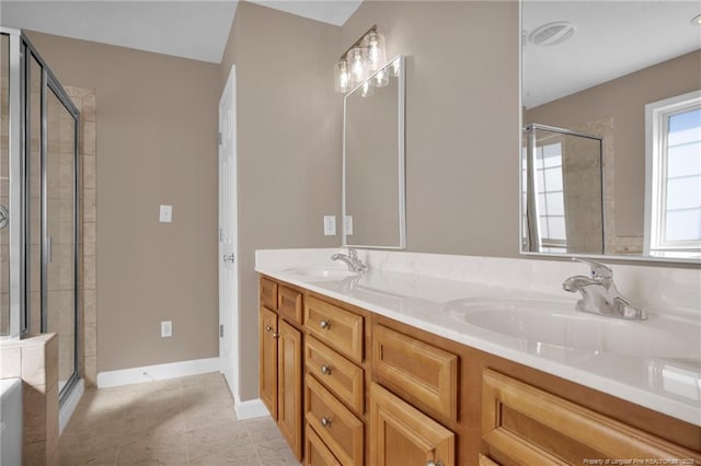 bathroom featuring a sink, a shower stall, baseboards, and double vanity