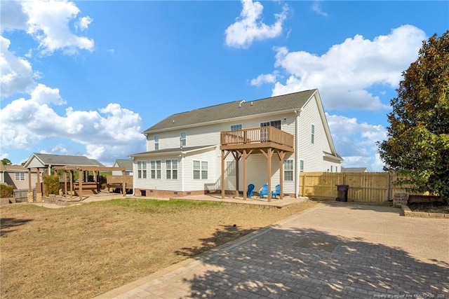 back of property featuring a yard, crawl space, a patio, and fence