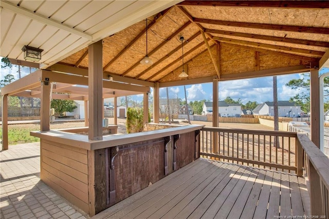 wooden deck featuring a residential view, fence, and an outdoor structure