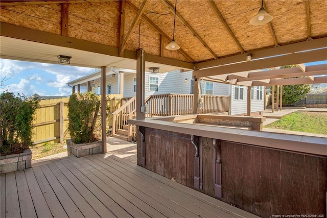 wooden deck with fence and a patio