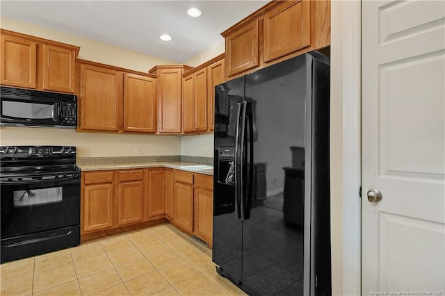 kitchen with light tile patterned flooring, recessed lighting, light countertops, black appliances, and brown cabinetry