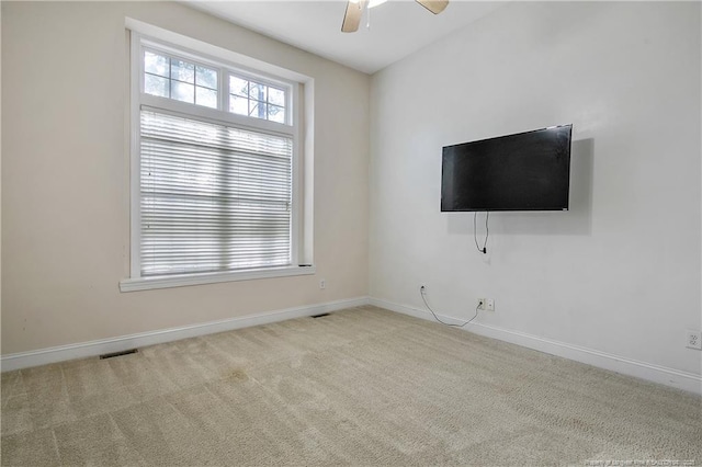 interior space featuring a ceiling fan, carpet flooring, visible vents, and baseboards