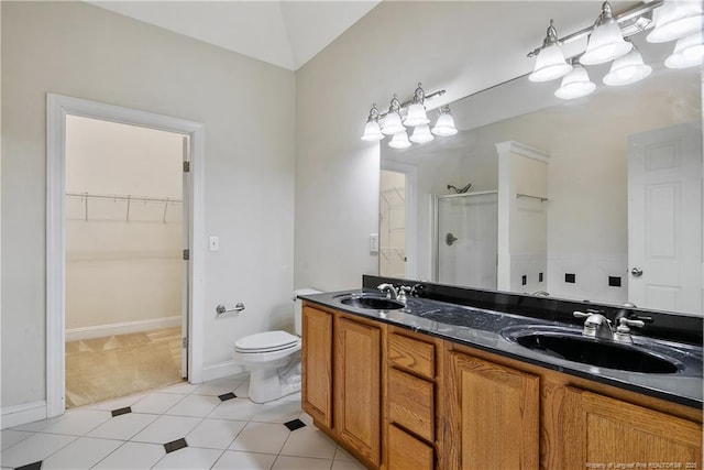 full bath featuring double vanity, a shower stall, a spacious closet, and a sink