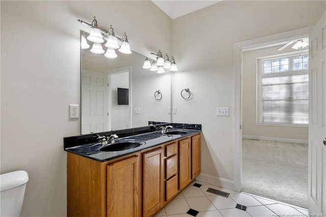 full bath featuring visible vents, a sink, baseboards, and double vanity