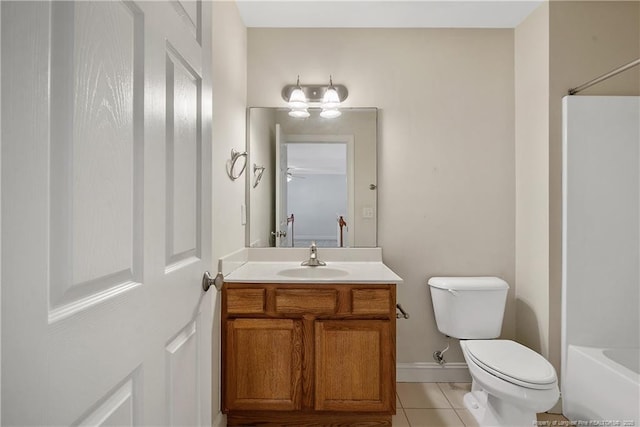 bathroom with baseboards, vanity, toilet, and tile patterned floors