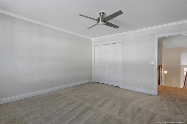 unfurnished bedroom with baseboards, carpet flooring, and crown molding