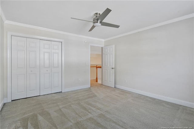 unfurnished bedroom with baseboards, carpet flooring, and crown molding