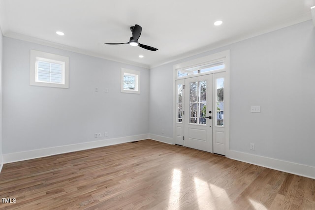 entrance foyer featuring recessed lighting, light wood-type flooring, baseboards, and ornamental molding