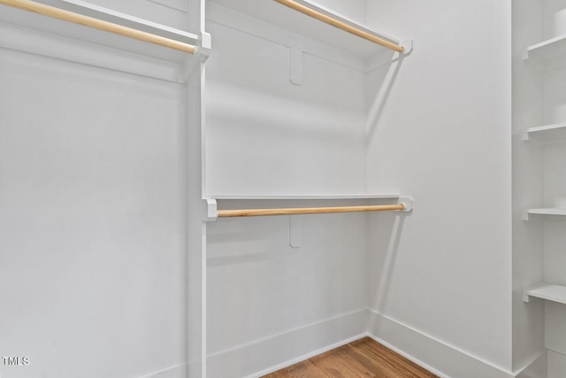 walk in closet featuring wood finished floors