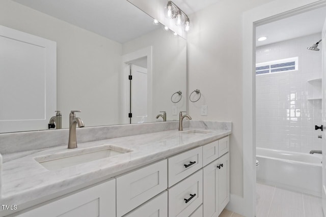 full bathroom featuring toilet, double vanity, shower / washtub combination, and a sink