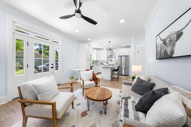 living area with baseboards, ornamental molding, a ceiling fan, and recessed lighting
