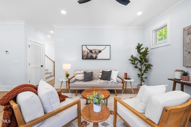 living area with crown molding, recessed lighting, stairs, and baseboards