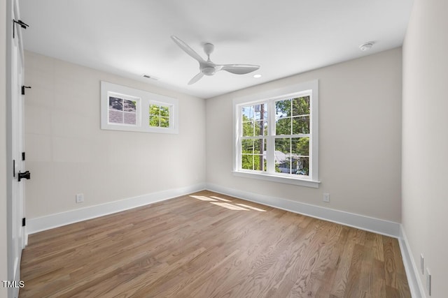 spare room with ceiling fan, recessed lighting, baseboards, wood finished floors, and visible vents
