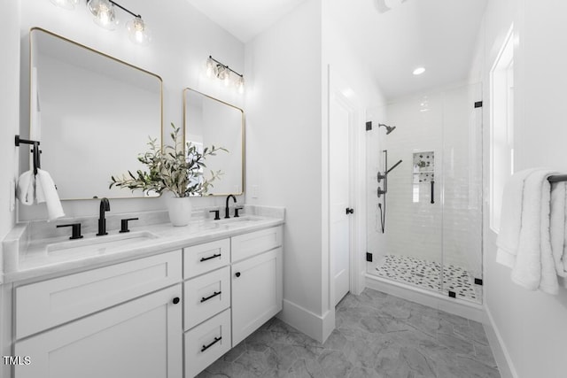 bathroom with a sink, baseboards, a stall shower, and marble finish floor