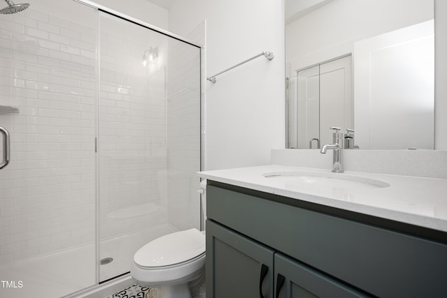 full bath with a stall shower, vanity, and toilet