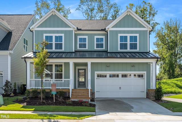 view of front of home with a standing seam roof, board and batten siding, covered porch, and a garage