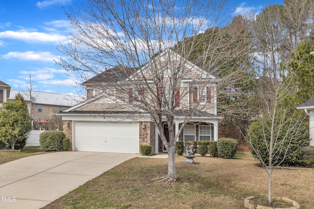 view of front facade with a front lawn, stone siding, an attached garage, and concrete driveway