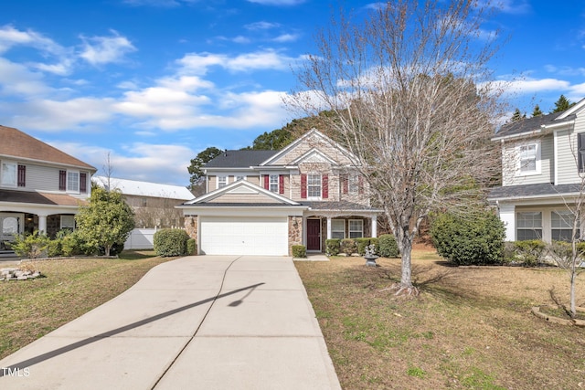 traditional-style home featuring driveway, a front lawn, an attached garage, and stone siding