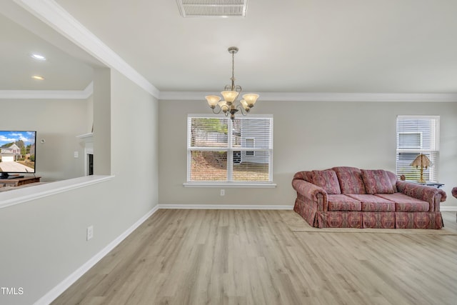 sitting room featuring ornamental molding, visible vents, baseboards, and wood finished floors